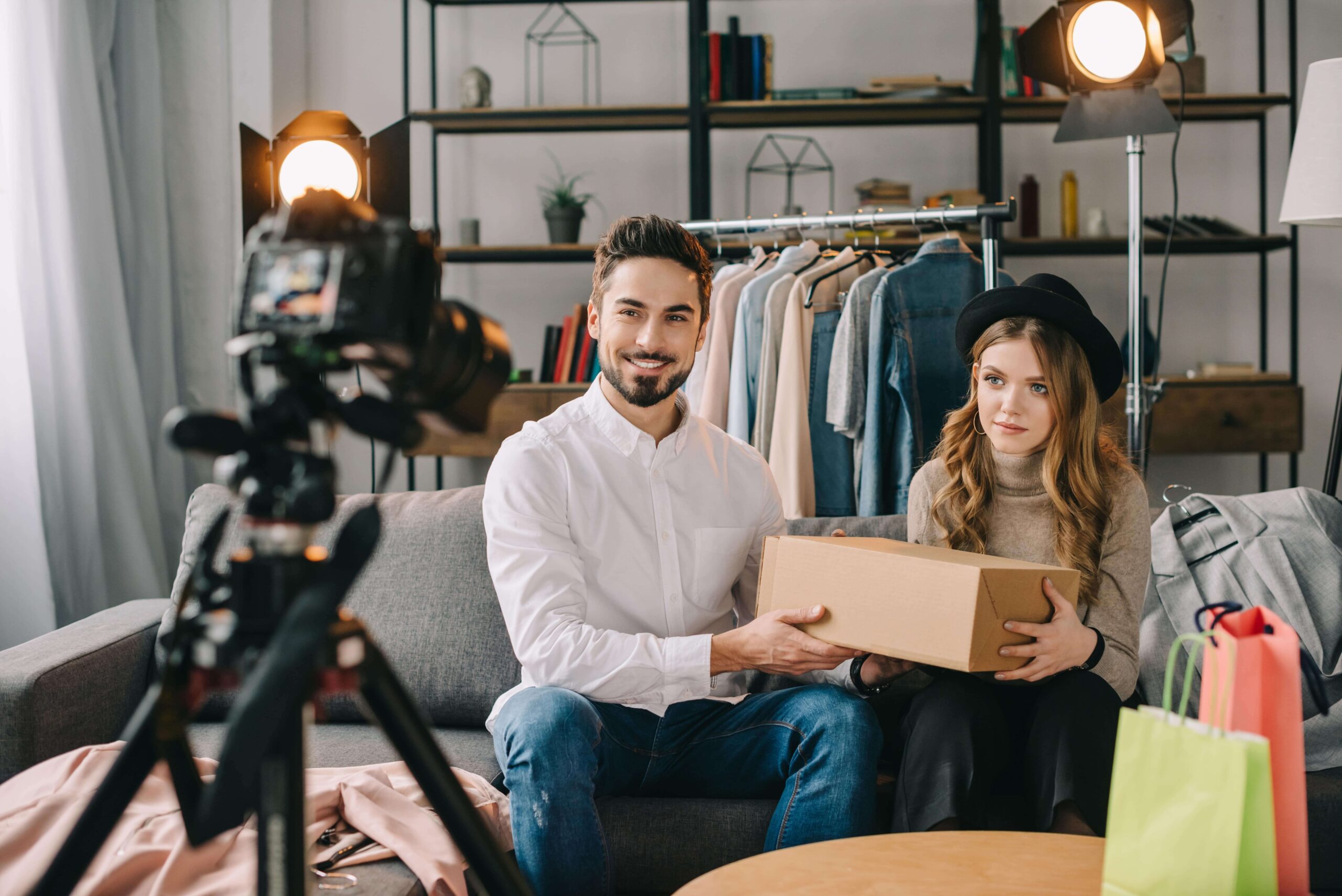 Male and female e-commerce influencers filming a new video to promote new products