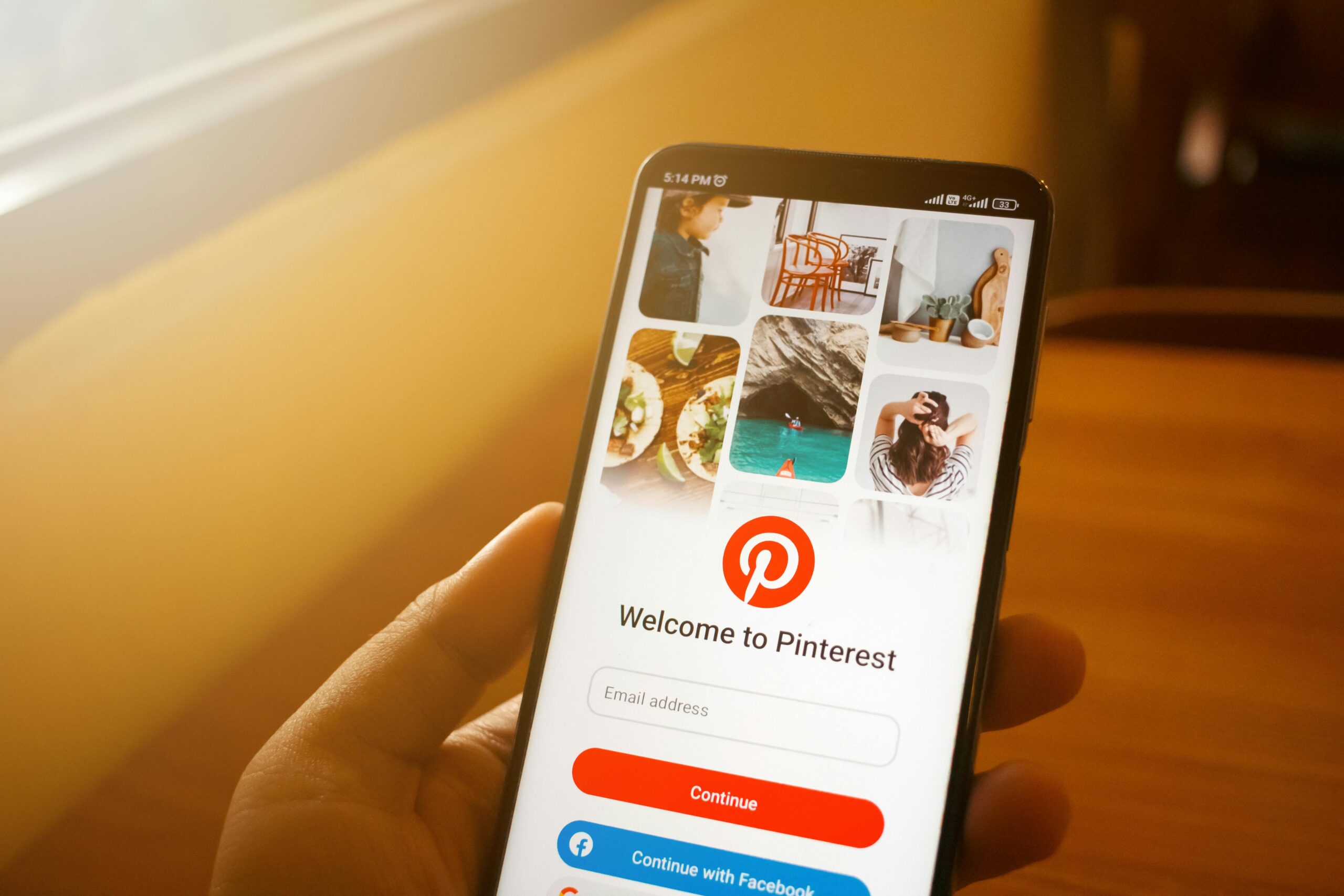 Person holding a phone with the Pinterest login page open